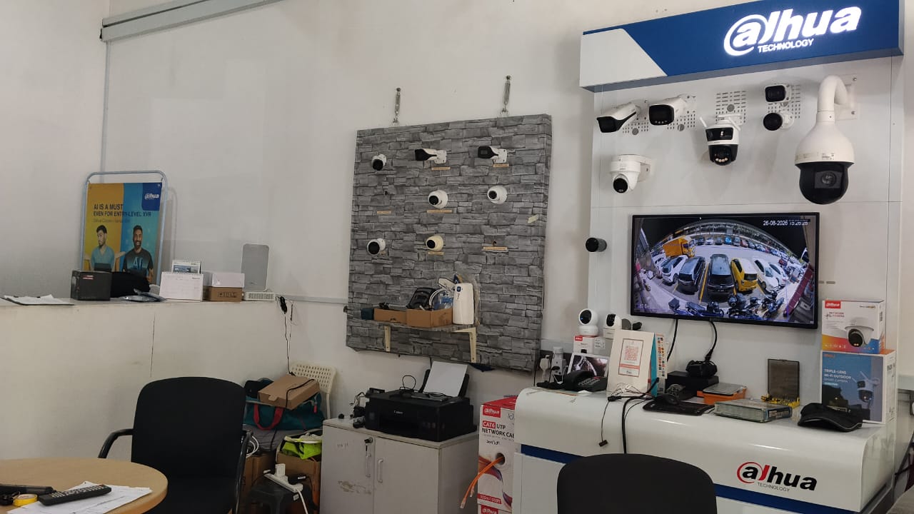 Zashtech showroom with Dahua Technology display wall showing live CCTV feed and camera models